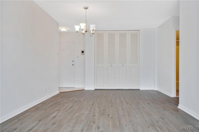 1088 Delaware Ave Unit 3B, Buffalo, NY 14209 - unfurnished dining area with a chandelier and wood finished floors