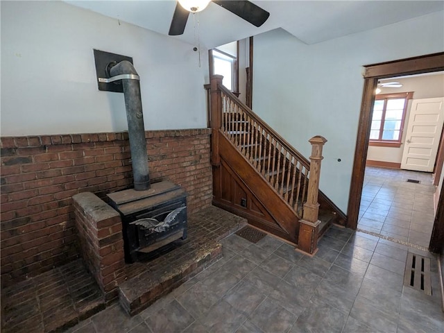 918 S Goodman St, Rochester, NY 14620 - stairway featuring a wood stove, ceiling fan, and tile patterned floors