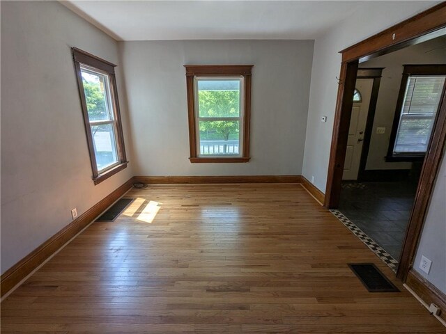 918 S Goodman St, Rochester, NY 14620 - empty room with wood finished floors and baseboards