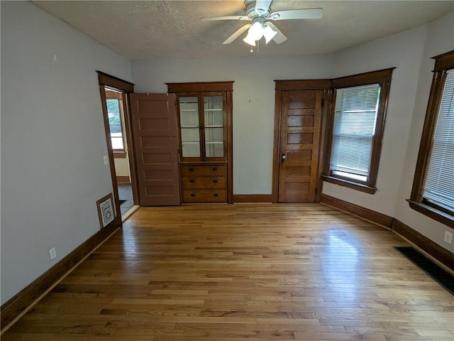 918 S Goodman St, Rochester, NY 14620 - empty room featuring light wood finished floors, a ceiling fan, and a textured ceiling