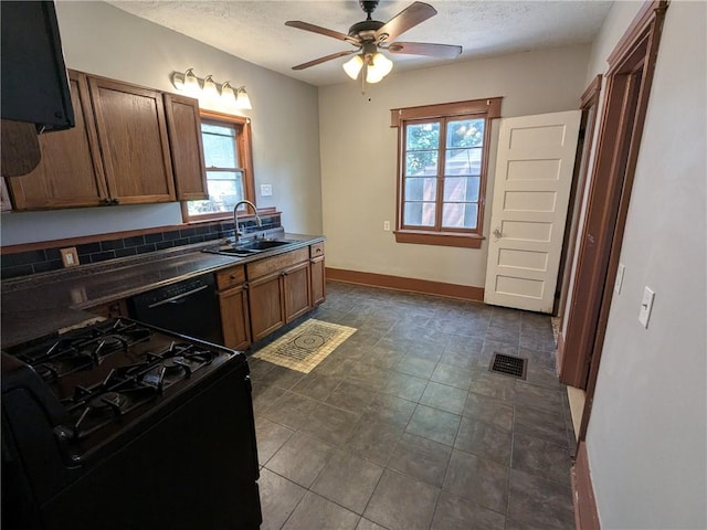 918 S Goodman St, Rochester, NY 14620 - kitchen with black appliances, dark countertops, a ceiling fan, a textured ceiling, and brown cabinets