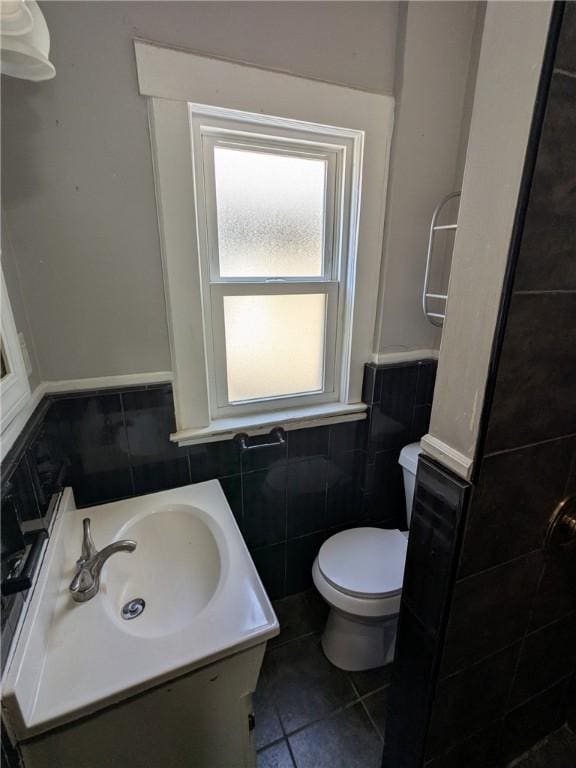 918 S Goodman St, Rochester, NY 14620 - bathroom with tile walls, vanity, tile patterned flooring, and wainscoting