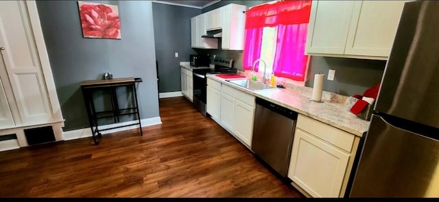 1206 W Water St, Elmira, NY 14905 - kitchen with appliances with stainless steel finishes, under cabinet range hood, dark wood-type flooring, white cabinets, and light stone counters