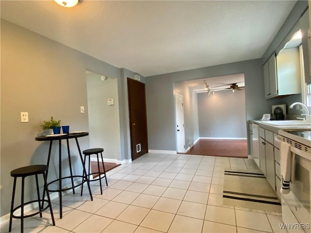 790 Mohawk St, Lewiston, NY 14092 - kitchen with light countertops, white appliances, light tile patterned flooring, and a ceiling fan