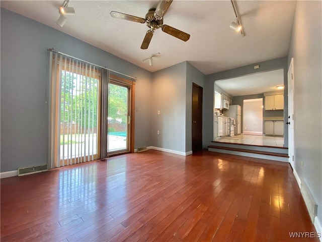790 Mohawk St, Lewiston, NY 14092 - unfurnished living room with rail lighting, a ceiling fan, and hardwood / wood-style floors