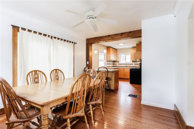 2092 Titus Ave, Irondequoit, NY 14622 - dining space with wood finished floors, ceiling fan, and crown molding