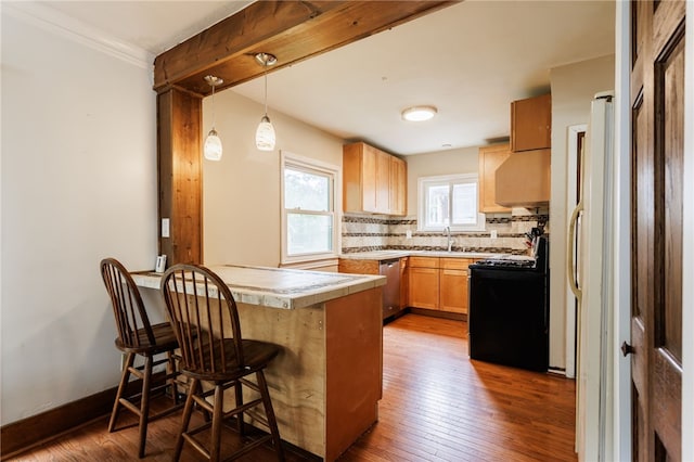 2092 Titus Ave, Irondequoit, NY 14622 - kitchen featuring black range oven, stainless steel dishwasher, a peninsula, dark wood-style flooring, and decorative backsplash