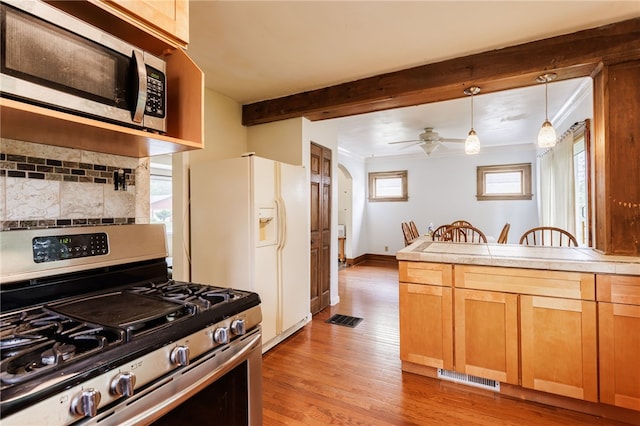 2092 Titus Ave, Irondequoit, NY 14622 - kitchen with stainless steel appliances, tasteful backsplash, light wood-style flooring, beam ceiling, and hanging light fixtures