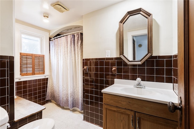 2092 Titus Ave, Irondequoit, NY 14622 - bathroom featuring tile walls, vanity, a wainscoted wall, curtained shower, and tile patterned flooring