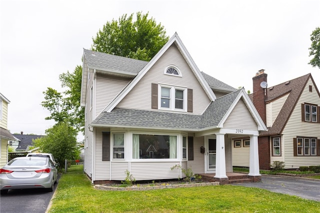 2092 Titus Ave, Irondequoit, NY 14622 - view of front of home featuring a shingled roof and a front lawn