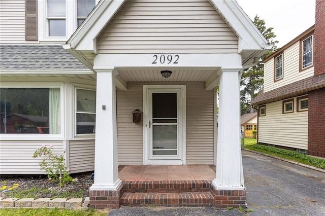 2092 Titus Ave, Irondequoit, NY 14622 - doorway to property with covered porch and a shingled roof