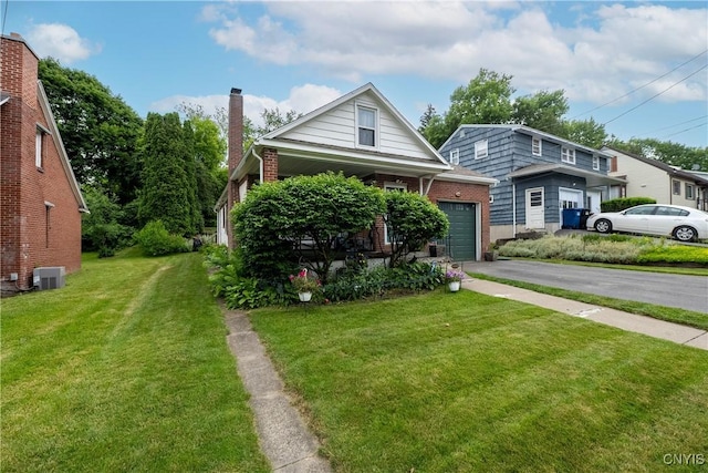 108 Phillips Rd, Syracuse, NY 13214 - view of front of property featuring asphalt driveway, brick siding, a front lawn, and a chimney