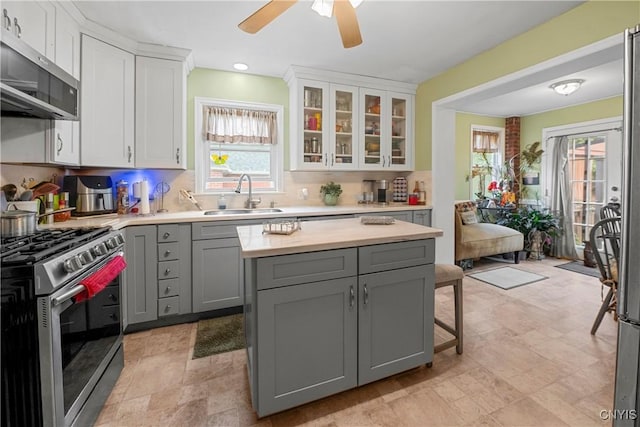 108 Phillips Rd, Syracuse, NY 13214 - kitchen featuring appliances with stainless steel finishes, gray cabinets, light countertops, white cabinetry, and decorative backsplash