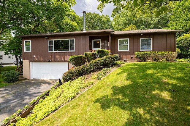 745 Maple Dr, Webster, NY 14580 - ranch-style house with driveway, an attached garage, board and batten siding, and a front yard