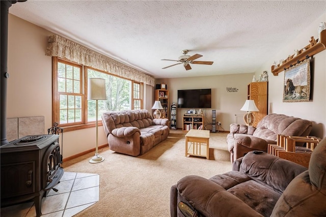 745 Maple Dr, Webster, NY 14580 - carpeted living area featuring a wood stove, ceiling fan, and a textured ceiling