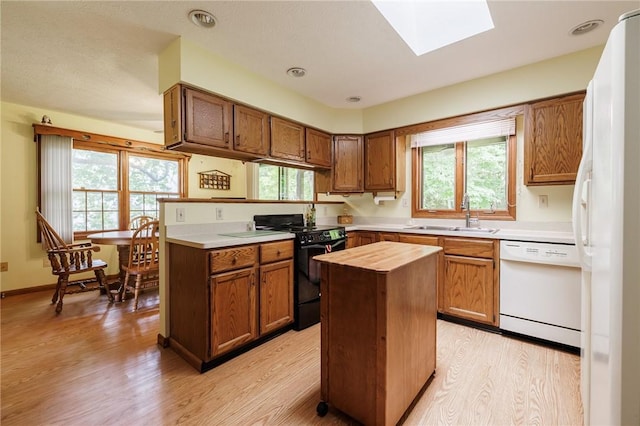 745 Maple Dr, Webster, NY 14580 - kitchen with white appliances, butcher block countertops, light wood-style floors, a skylight, and plenty of natural light