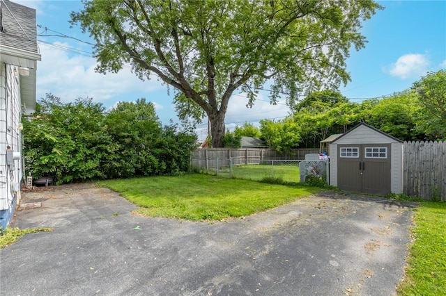 434 Crossfield Rd, Irondequoit, NY 14609 - fenced backyard featuring a storage unit and a patio area