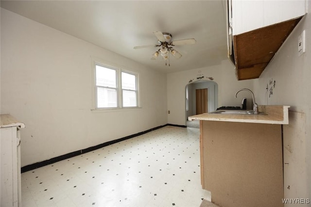 34 Schiller St, Buffalo, NY 14206 - kitchen with light floors, arched walkways, a ceiling fan, and light countertops
