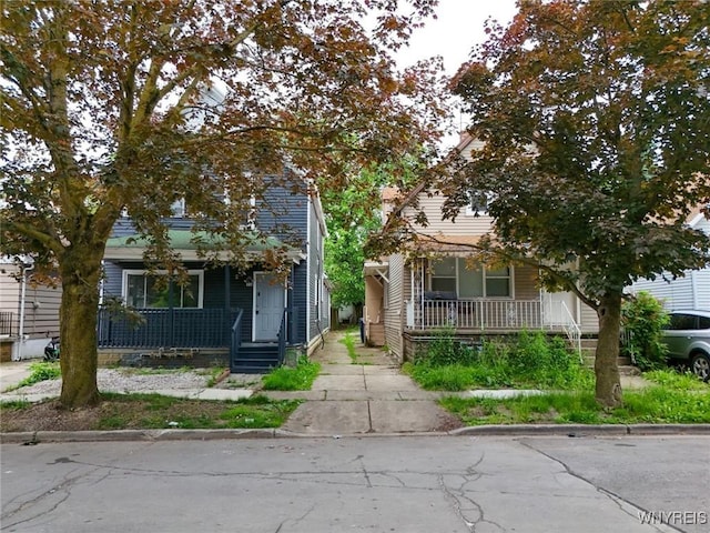 34 Schiller St, Buffalo, NY 14206 - view of property hidden behind natural elements featuring covered porch