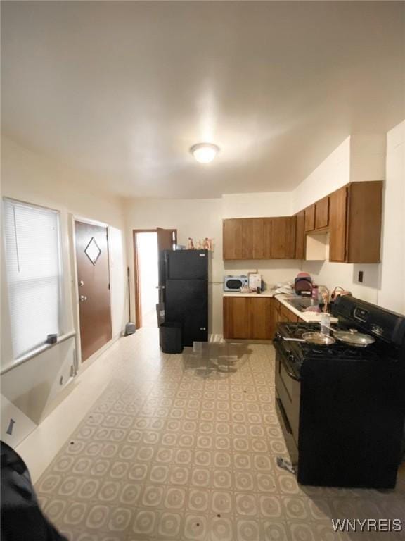34 Schiller St, Buffalo, NY 14206 - kitchen featuring black appliances, brown cabinets, and light countertops
