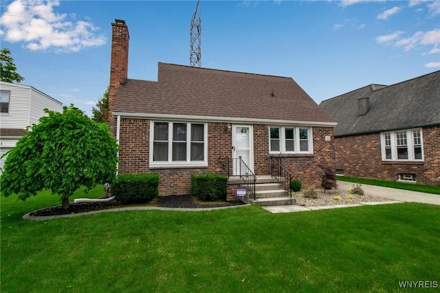 25 Cresthaven Dr, Cheektowaga, NY 14225 - view of front of house featuring a front yard, a chimney, brick siding, and a shingled roof