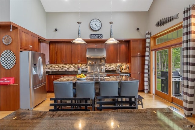 32 Coblesub Rd, West Monroe, NY 13036 - kitchen with stainless steel fridge with ice dispenser, under cabinet range hood, a towering ceiling, dark countertops, and backsplash