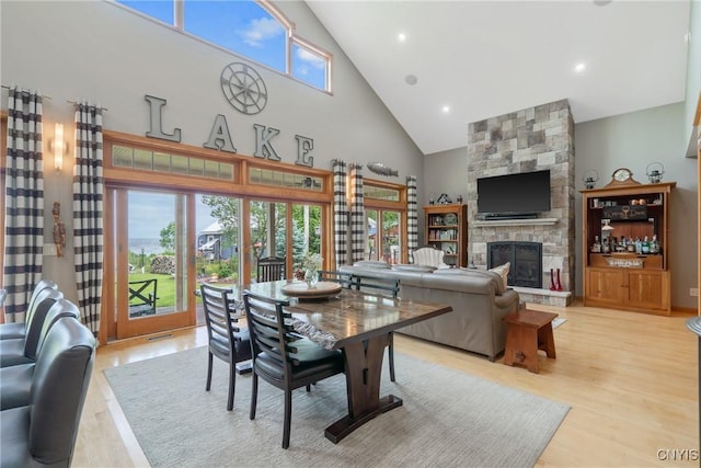32 Coblesub Rd, West Monroe, NY 13036 - dining room featuring high vaulted ceiling, light wood-style floors, and a stone fireplace