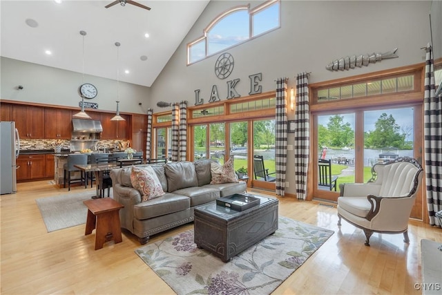 32 Coblesub Rd, West Monroe, NY 13036 - living area featuring high vaulted ceiling, light wood finished floors, plenty of natural light, and a ceiling fan