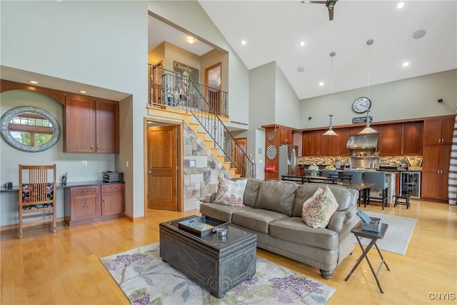 32 Coblesub Rd, West Monroe, NY 13036 - living area featuring high vaulted ceiling, light wood finished floors, wine cooler, and stairs