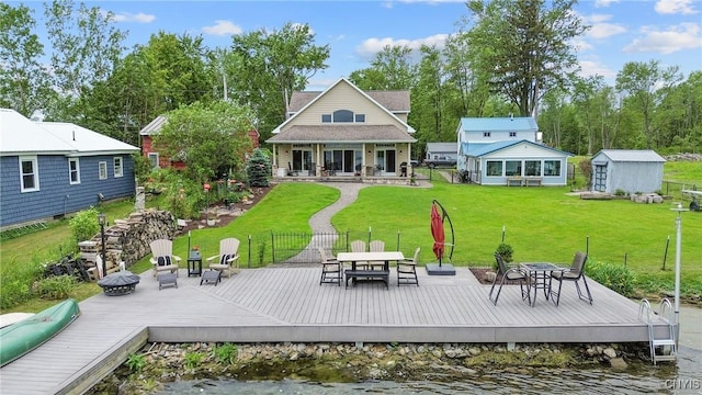 32 Coblesub Rd, West Monroe, NY 13036 - back of property with a deck with water view, outdoor dining space, and a storage unit