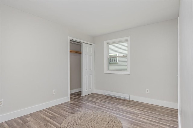 2761 Mount Read Blvd, Greece, NY 14616 - unfurnished bedroom with wood finished floors and a closet