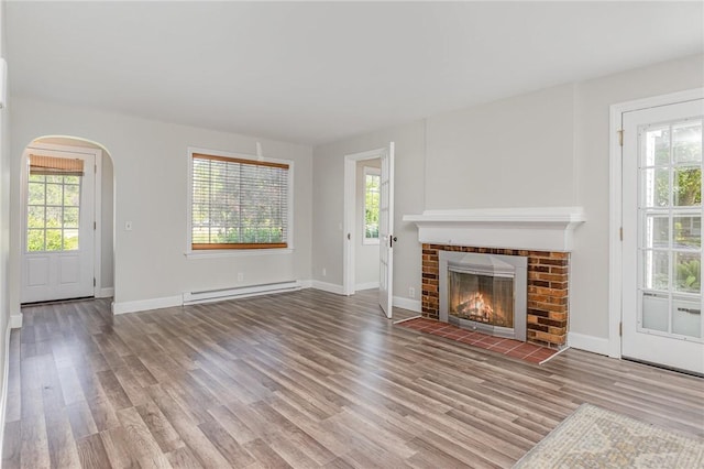 2761 Mount Read Blvd, Greece, NY 14616 - unfurnished living room with a baseboard heating unit, arched walkways, and healthy amount of natural light