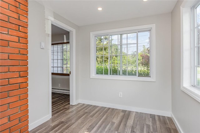 2761 Mount Read Blvd, Greece, NY 14616 - unfurnished room with a baseboard radiator, wood finished floors, and recessed lighting