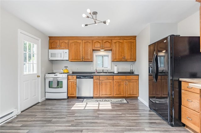 2761 Mount Read Blvd, Greece, NY 14616 - kitchen with white appliances, brown cabinetry, a chandelier, baseboard heating, and wood finished floors