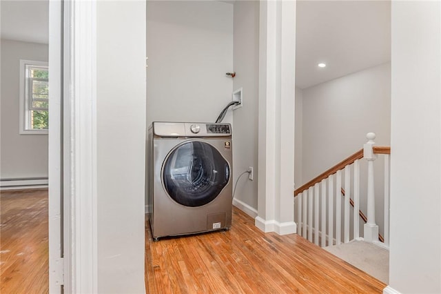 2761 Mount Read Blvd, Greece, NY 14616 - laundry room featuring washer / dryer, baseboard heating, and wood finished floors