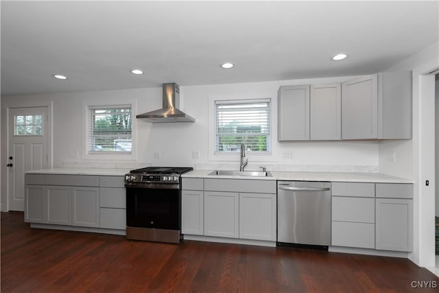 7446 Collamer Rd, Manlius, NY 13057 - kitchen with stainless steel appliances, wall chimney range hood, plenty of natural light, light countertops, and recessed lighting