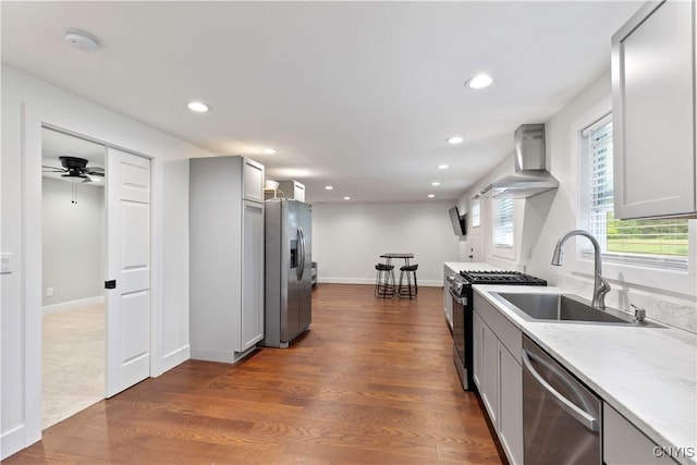 7446 Collamer Rd, Manlius, NY 13057 - kitchen with appliances with stainless steel finishes, gray cabinets, wall chimney range hood, recessed lighting, and dark wood-style floors