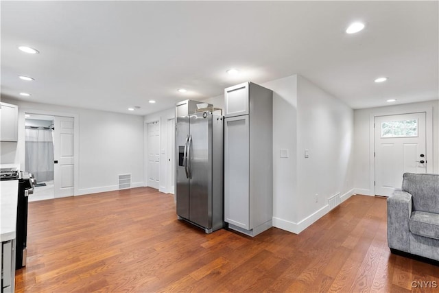 7446 Collamer Rd, Manlius, NY 13057 - kitchen featuring appliances with stainless steel finishes, recessed lighting, wood finished floors, light countertops, and open floor plan