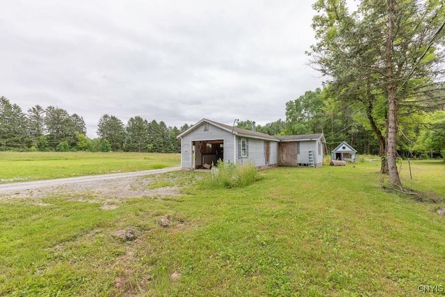 7446 Collamer Rd, Manlius, NY 13057 - view of front of house with an outdoor structure, a front lawn, and driveway