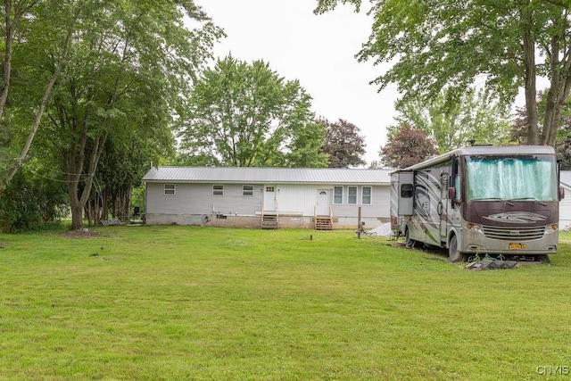 7446 Collamer Rd, Manlius, NY 13057 - back of property featuring entry steps, a lawn, a metal roof, and crawl space