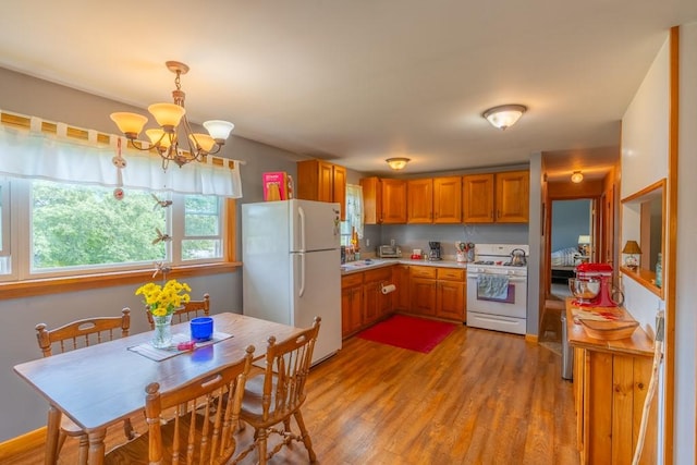 2226 Deiter Rd, Wayland, NY 14572 - kitchen featuring white appliances, a chandelier, light countertops, brown cabinets, and light wood-style flooring