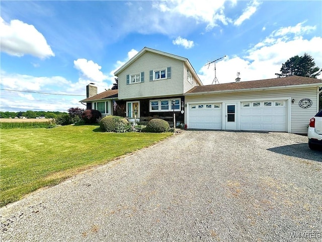 9718 Pearson Rd, Hartland, NY 14105 - view of front facade featuring driveway, a garage, and a front yard