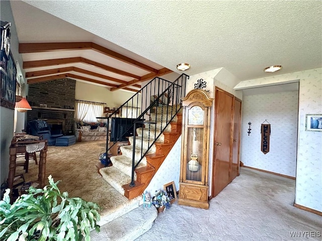 9718 Pearson Rd, Hartland, NY 14105 - stairs with carpet flooring, vaulted ceiling, a large fireplace, and wallpapered walls
