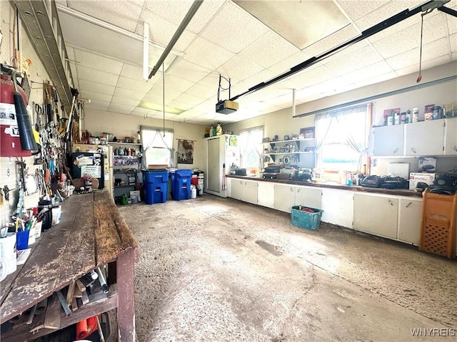 9718 Pearson Rd, Hartland, NY 14105 - garage with a workshop area and a garage door opener