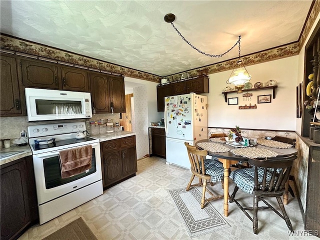 9718 Pearson Rd, Hartland, NY 14105 - kitchen featuring white appliances, light floors, dark brown cabinets, light countertops, and wainscoting