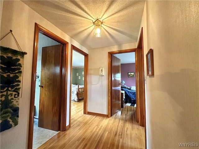 9718 Pearson Rd, Hartland, NY 14105 - hallway featuring light wood-type flooring and baseboards