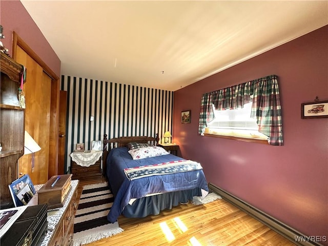 9718 Pearson Rd, Hartland, NY 14105 - bedroom featuring a baseboard heating unit and wood finished floors