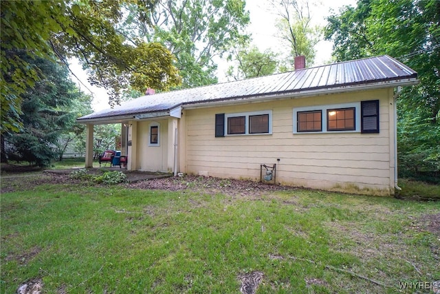 711 Sandy Ave, Evans, NY 14006 - view of front facade featuring a chimney, a metal roof, and a front lawn