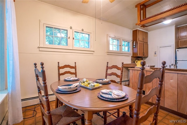 711 Sandy Ave, Evans, NY 14006 - dining area with a baseboard heating unit and light tile patterned floors