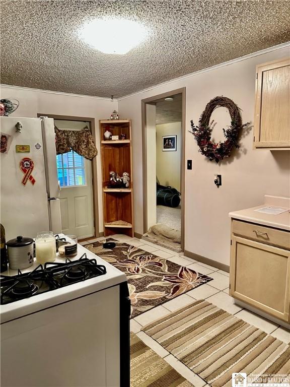 417 4th Ave, Olean-City, NY 14760 - kitchen featuring white appliances, a textured ceiling, light countertops, light brown cabinets, and light tile patterned flooring